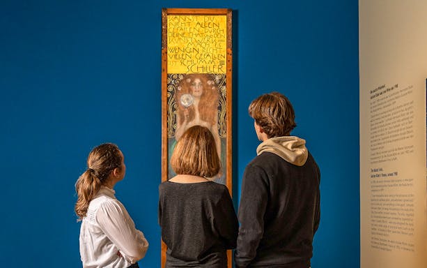 Visitors viewing a Gustav Klimt painting at Palais Lobkowitz.