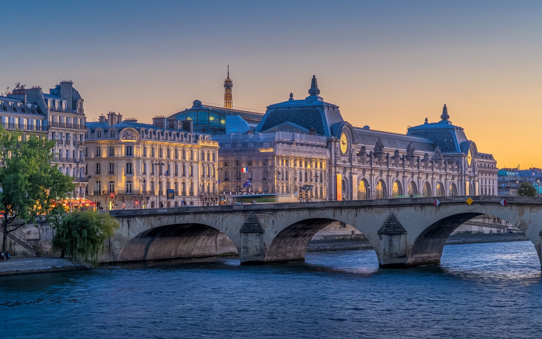 Orsay Museum and Eiffel Tower at dusk during Paris Illumination Tour.