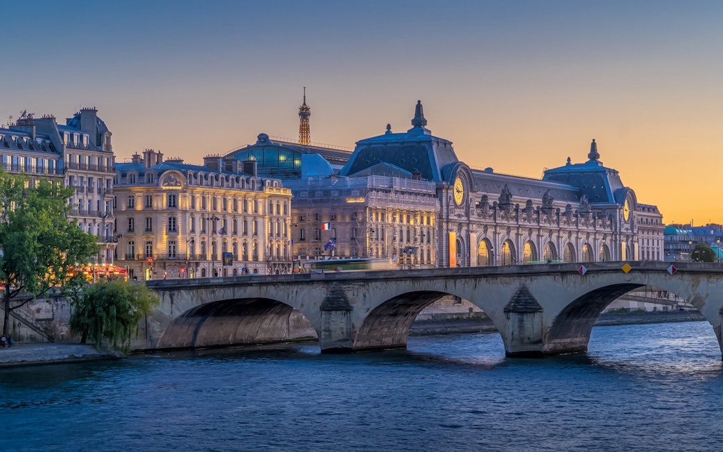 Orsay Museum and Eiffel Tower at dusk during Paris Illumination Tour.