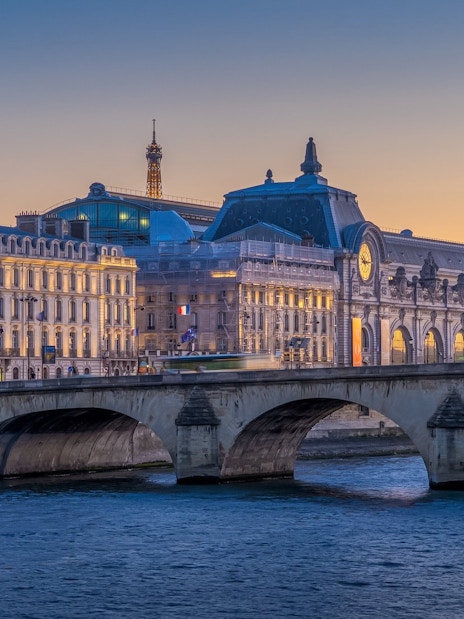 Orsay Museum and Eiffel Tower at dusk during Paris Illumination Tour.