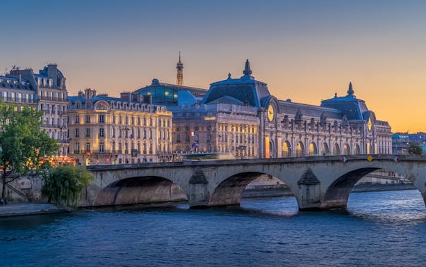 Orsay Museum and Eiffel Tower at dusk during Paris Illumination Tour.