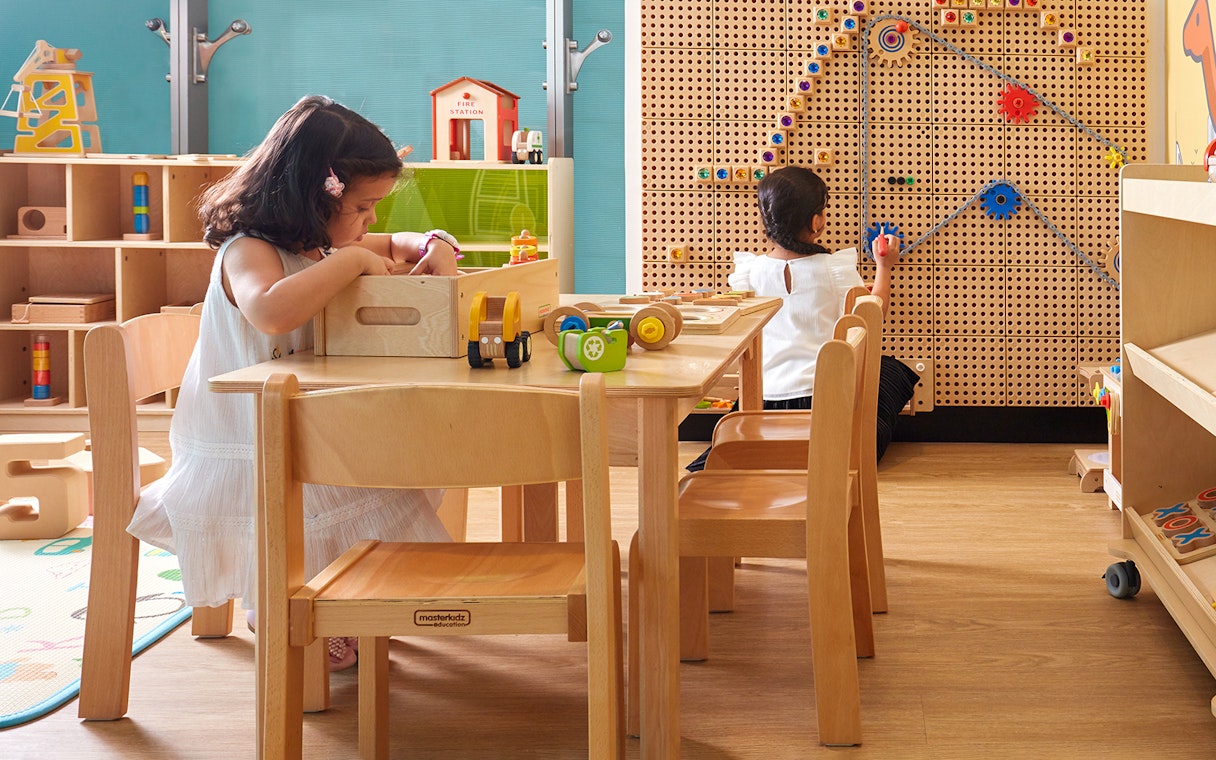 Children playing in a kids' area at Dubai International Airport premium lounge.