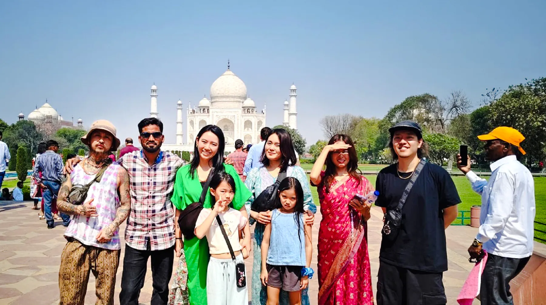 Group of tourists in front of the Taj Mahal during a tour from Delhi, Agra.