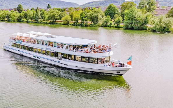 Koblenz river cruise boat with passengers enjoying scenic views.