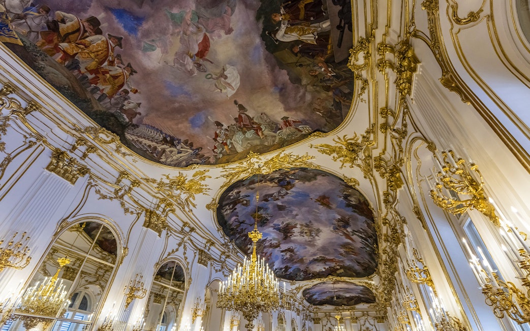Ornate ceiling frescoes and chandeliers in Schönbrunn Palace, Vienna.