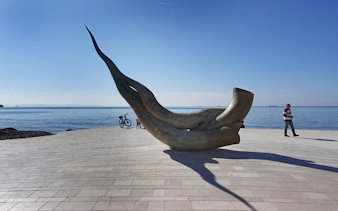 Seashell statue on Durrës beach, Albania with ocean backdrop.