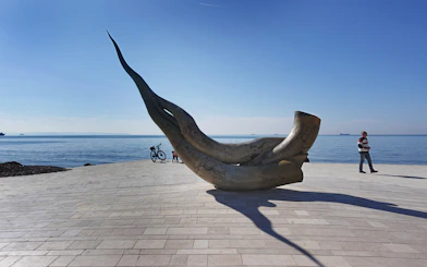 Seashell statue on Durrës beach, Albania with ocean backdrop.
