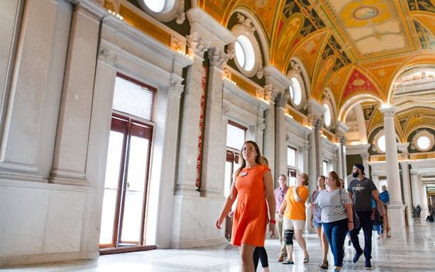 Guide leading tourists through Capitol Building library in Washington D.C.