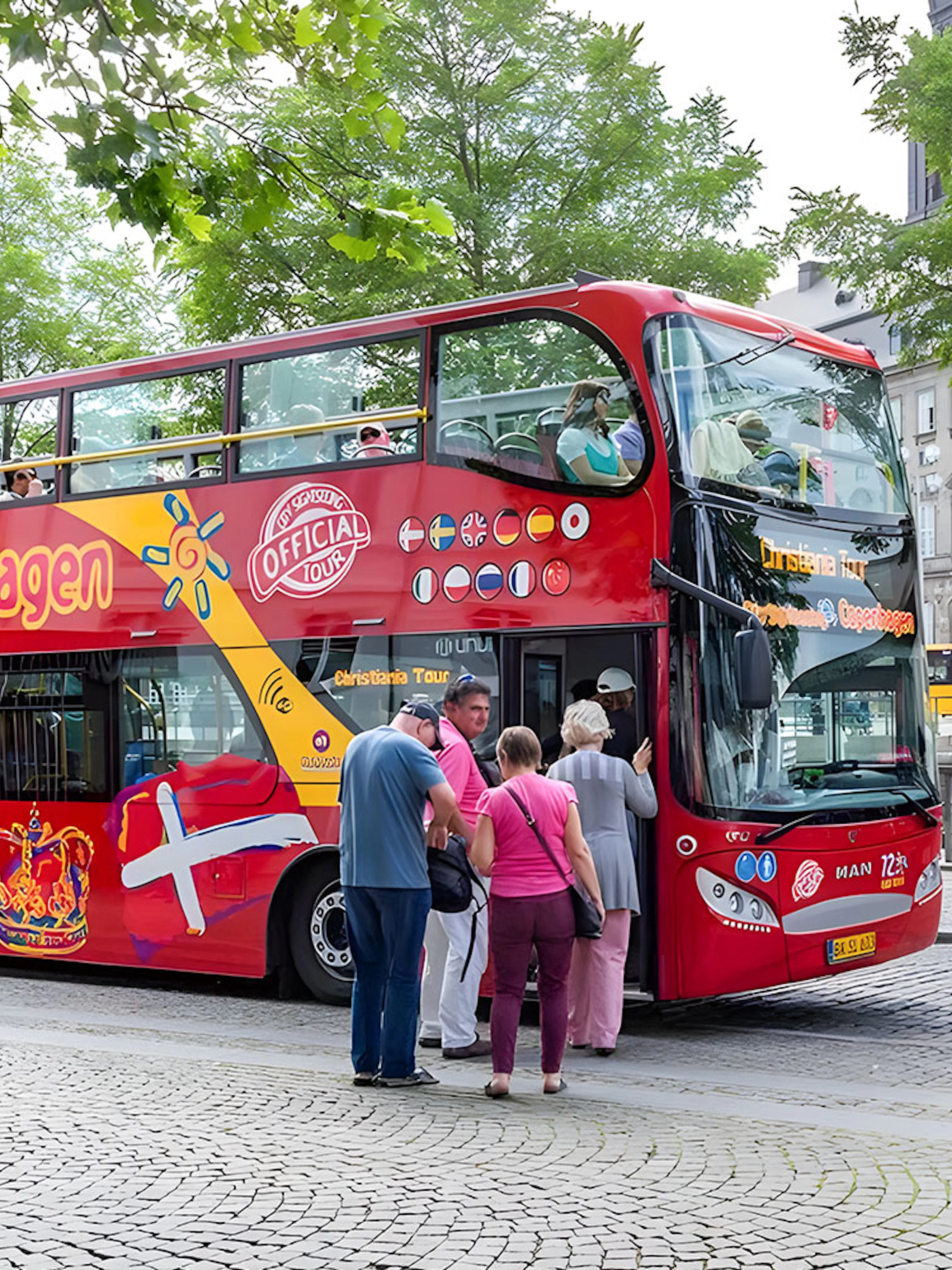 Tourists boarding a red hop-on hop-off bus in Copenhagen.