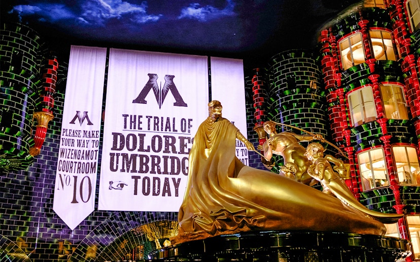 Trial banner and golden statue at Harry Potter and the Battle at the Ministry, Epic Universe, Orlando.
