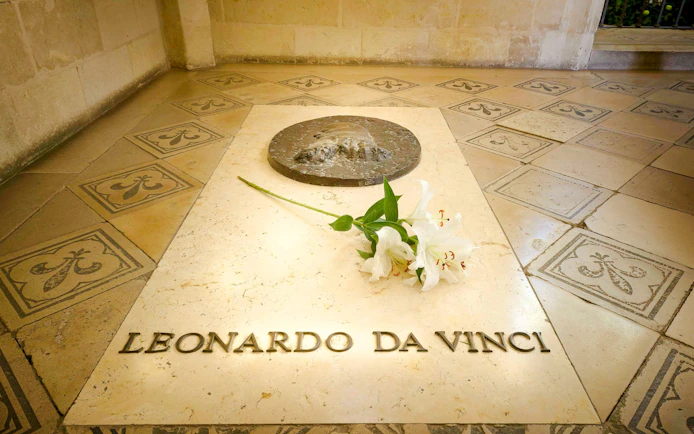 Tomb of Leonardo da Vinci with white lilies at Amboise Royal Castle, France.