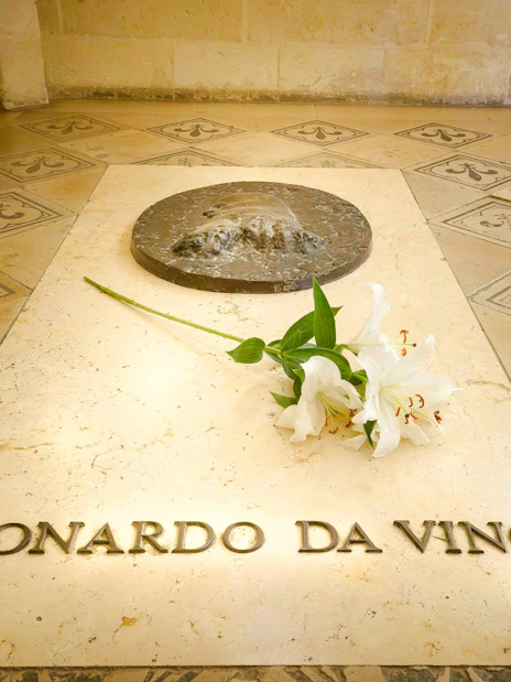 Tomb of Leonardo da Vinci with white lilies at Amboise Royal Castle, France.