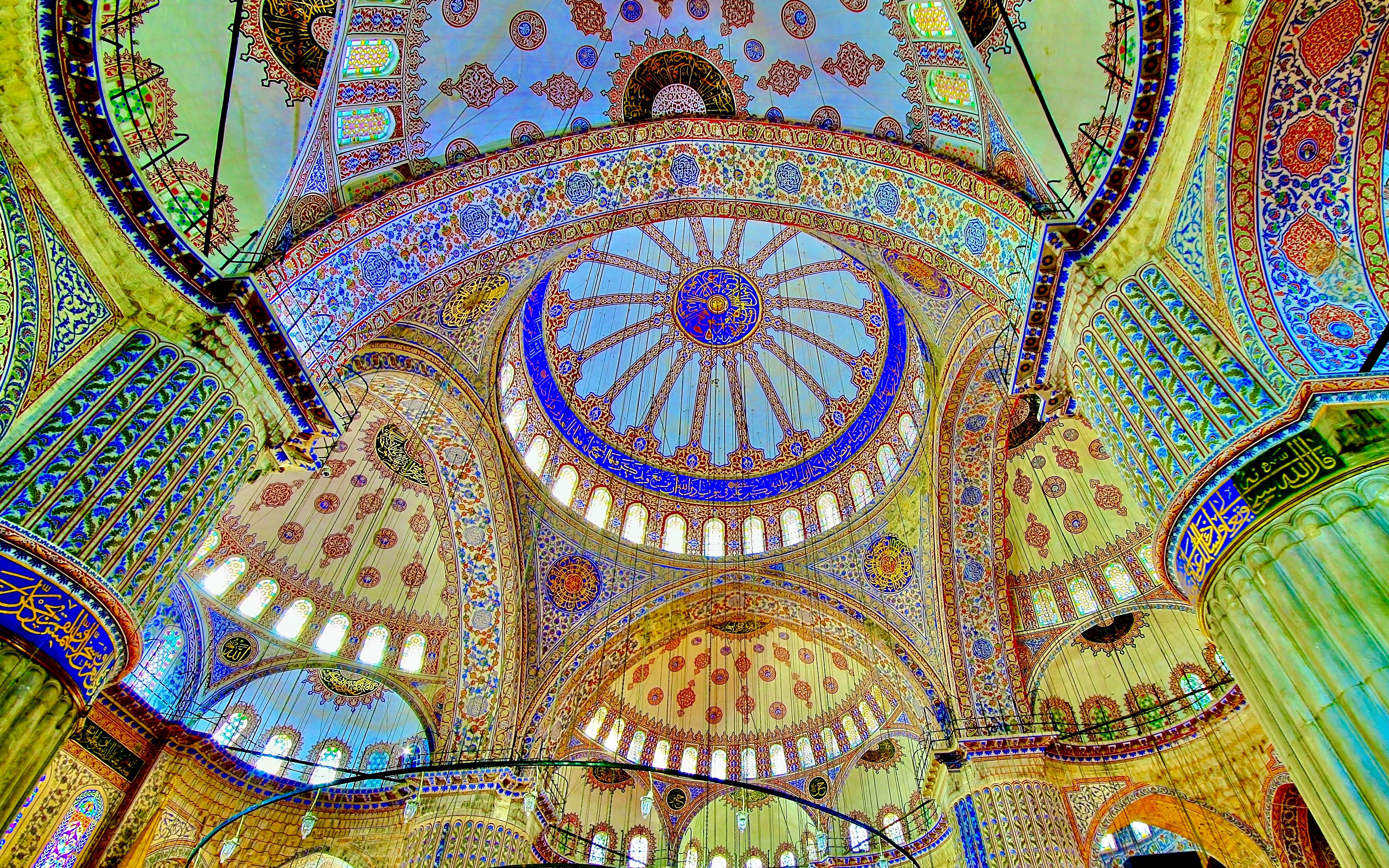 Ceiling of the Blue Mosque in Istanbul with intricate patterns and vibrant colors.