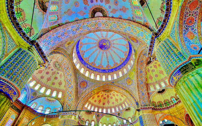 Ceiling of the Blue Mosque in Istanbul with intricate patterns and vibrant colors.
