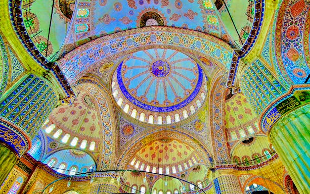 Ceiling of the Blue Mosque in Istanbul with intricate patterns and vibrant colors.