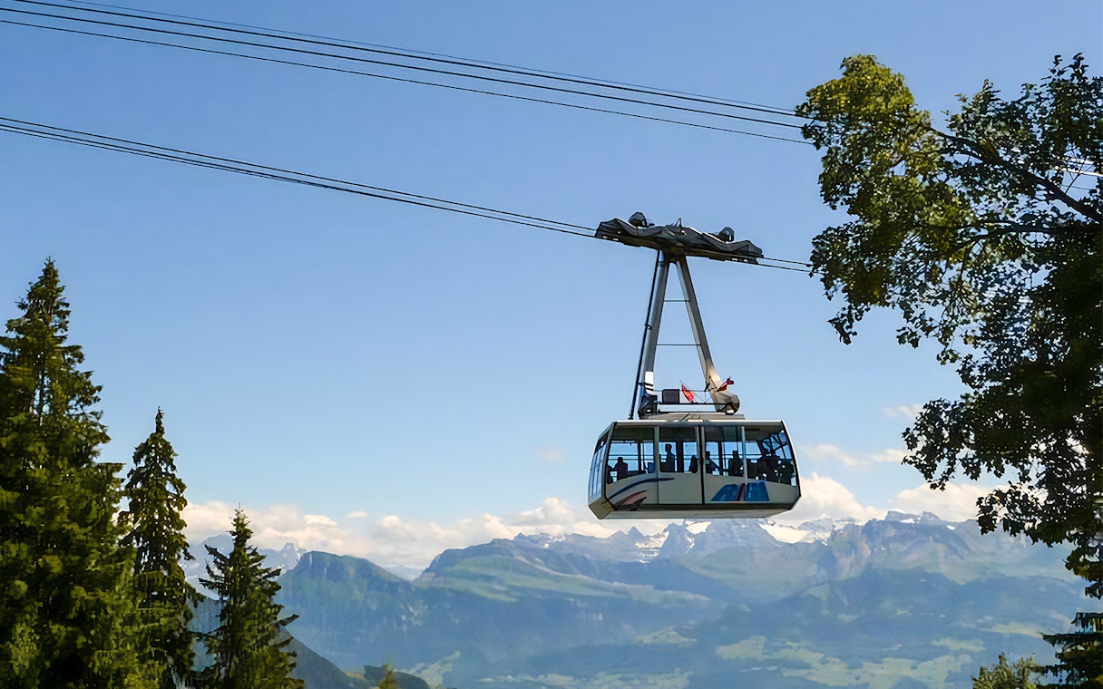 Cable car ascending Mount Rigi with scenic mountain views in Switzerland.