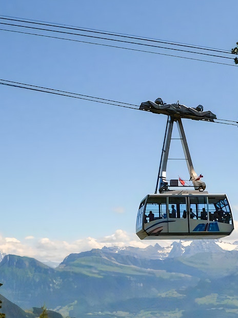Cable car ascending Mount Rigi with scenic mountain views in Switzerland.