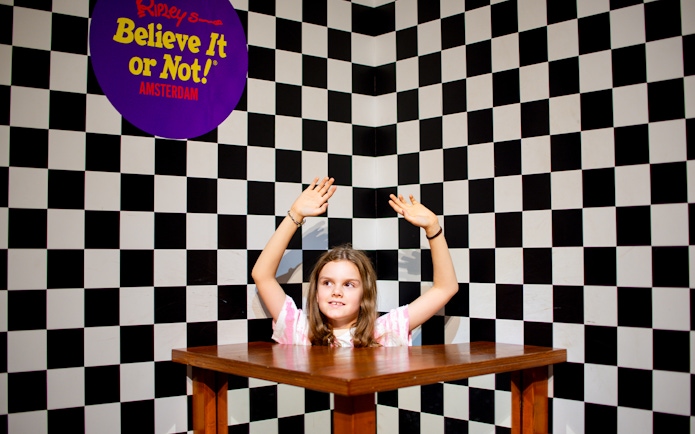 Child in optical illusion exhibit at Ripley's Believe It or Not! Amsterdam.
