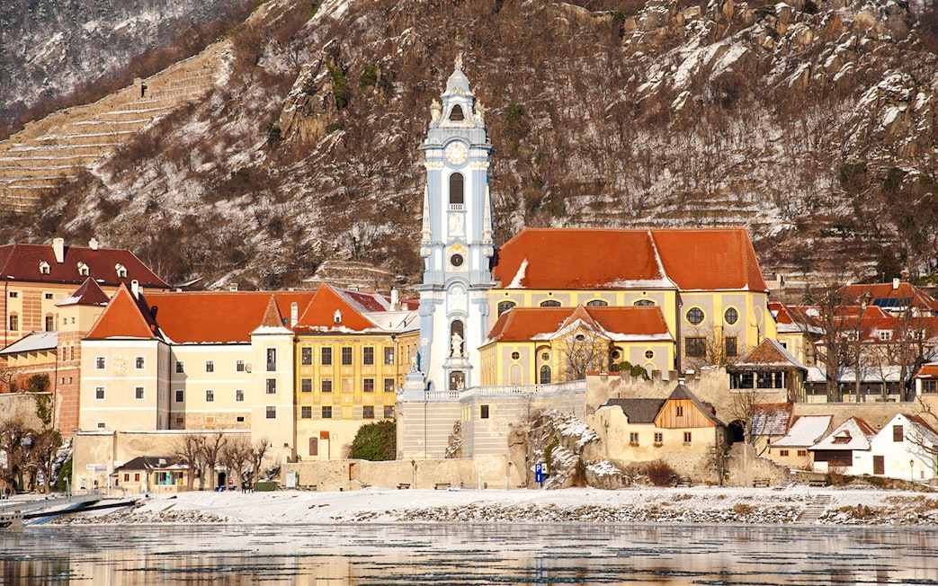 Dürnstein Abbey with snowy hills in Danube Valley, Austria, during winter.