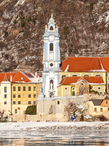Dürnstein Abbey with snowy hills in Danube Valley, Austria, during winter.