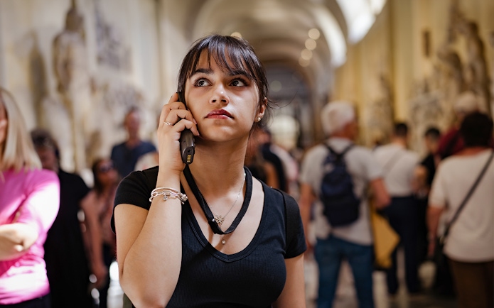 Visitor listening to an audio guide inside Siena Cathedral.