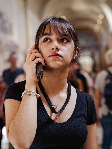 Visitor listening to an audio guide inside Siena Cathedral.