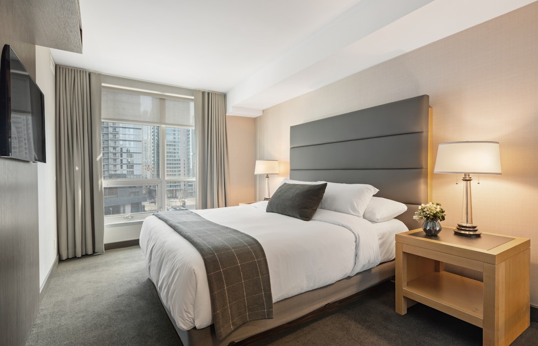 Italia in Miniatura hotel room with twin beds and balcony view of miniature landmarks.