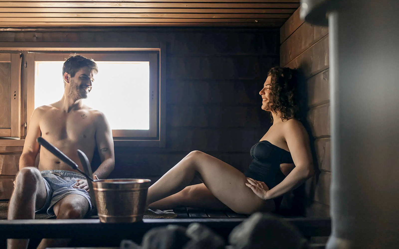 Guests relaxing in a sauna during Northern lights experience in Rovaniemi.