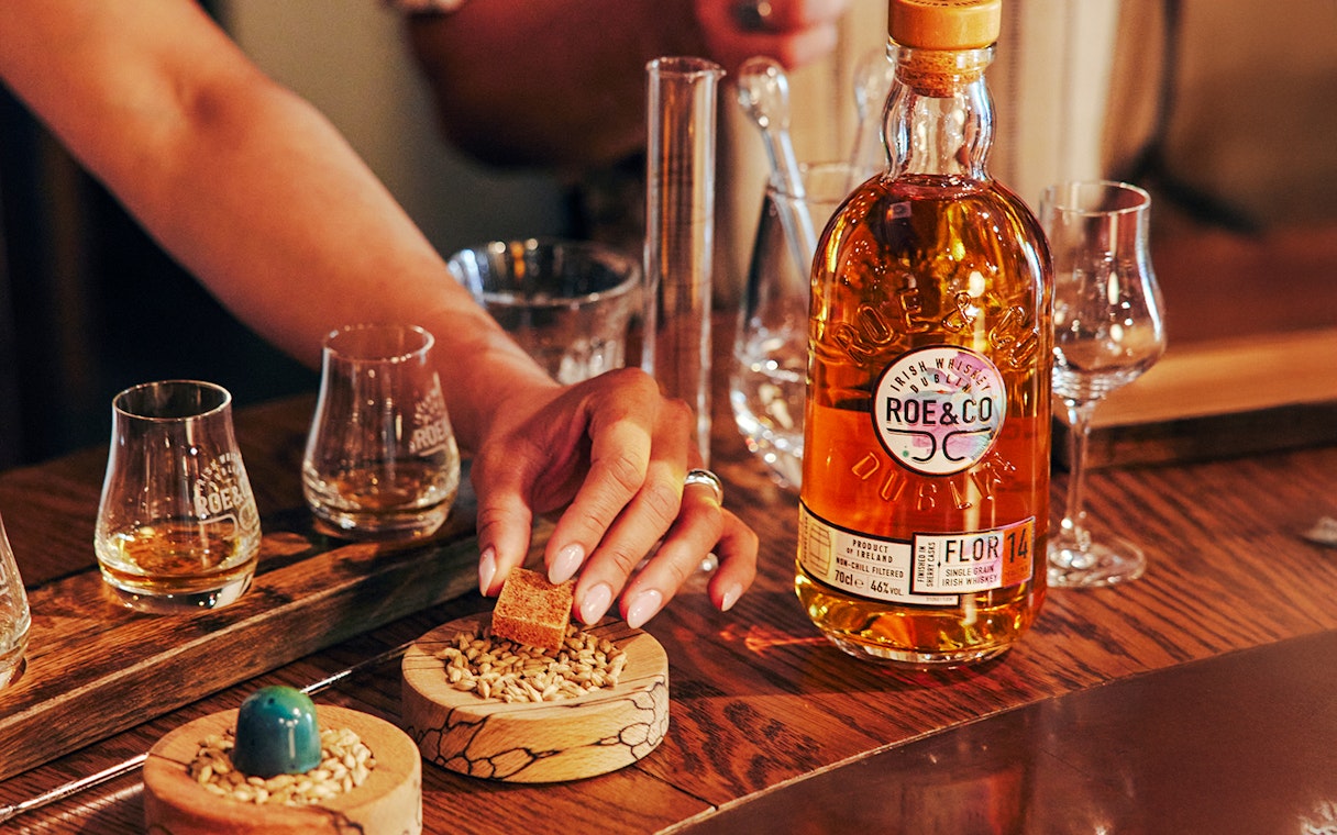 Roe & Co Distillery whiskey tasting setup with glasses and ingredients.