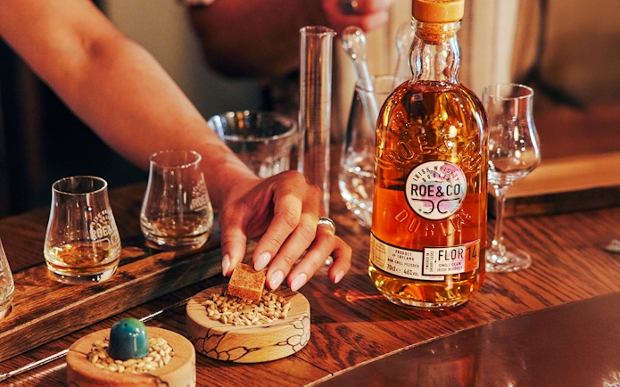 Roe & Co Distillery whiskey tasting setup with glasses and ingredients.