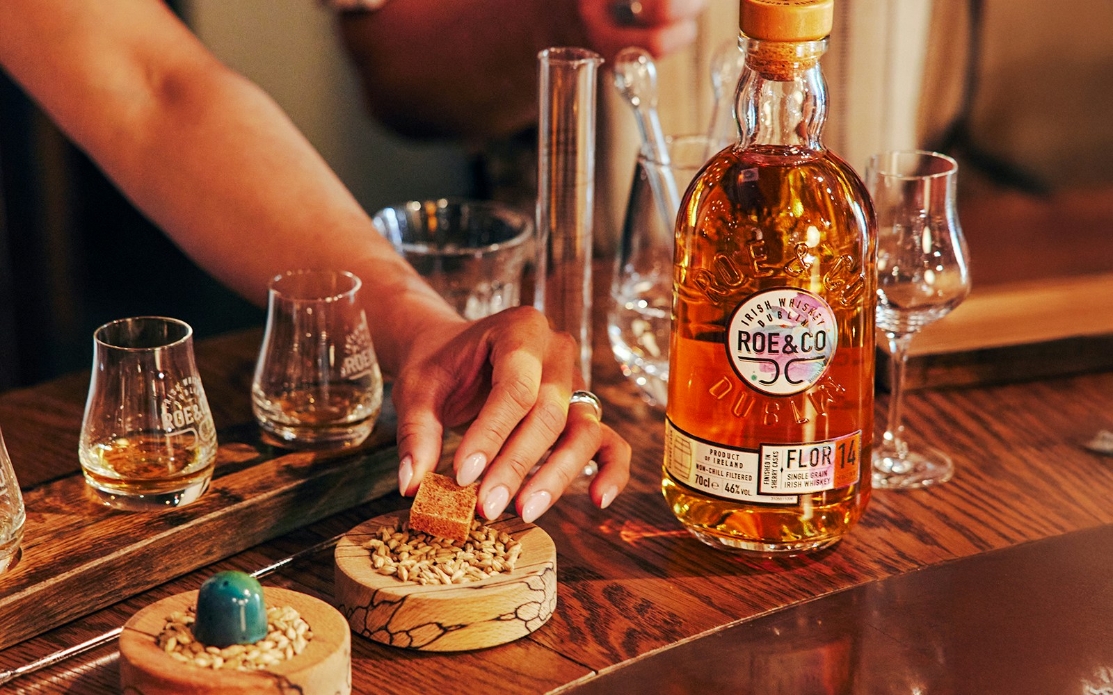Roe & Co Distillery whiskey tasting setup with glasses and ingredients.