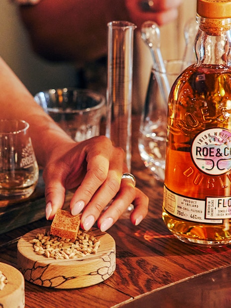 Roe & Co Distillery whiskey tasting setup with glasses and ingredients.