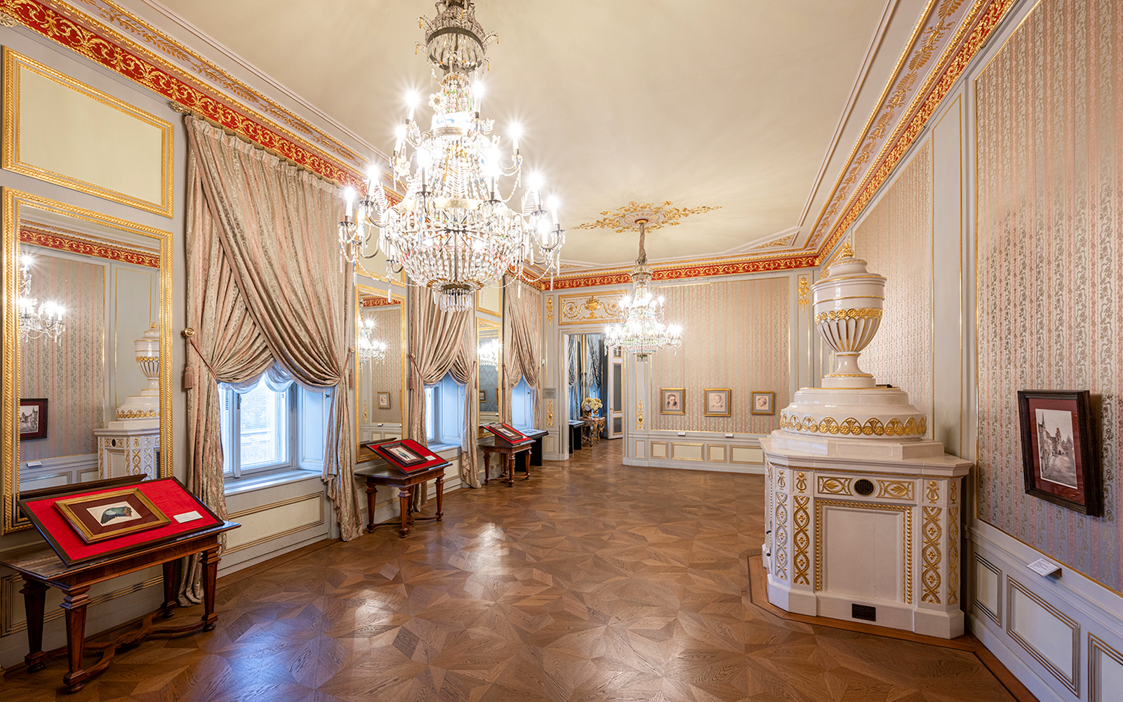State rooms with chandeliers and ornate decor inside Albertina Museum, Vienna.