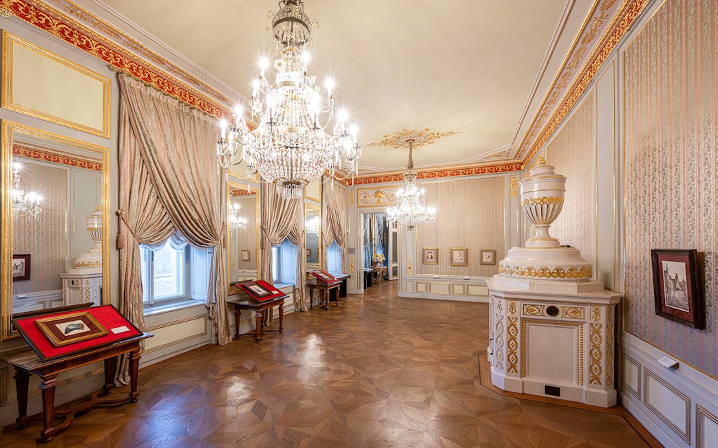 State rooms with chandeliers and ornate decor inside Albertina Museum, Vienna.
