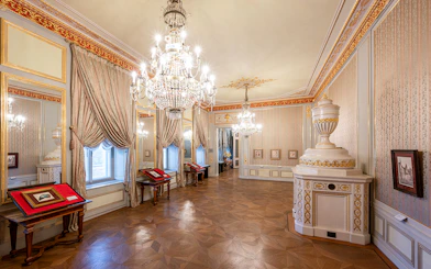 State rooms with chandeliers and ornate decor inside Albertina Museum, Vienna.