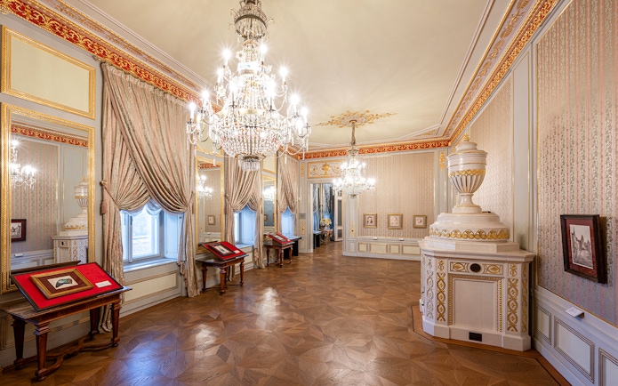 State rooms with chandeliers and ornate decor inside Albertina Museum, Vienna.