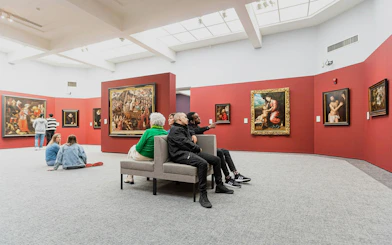 Visitors viewing art in Groeningemuseum gallery, Bruges.