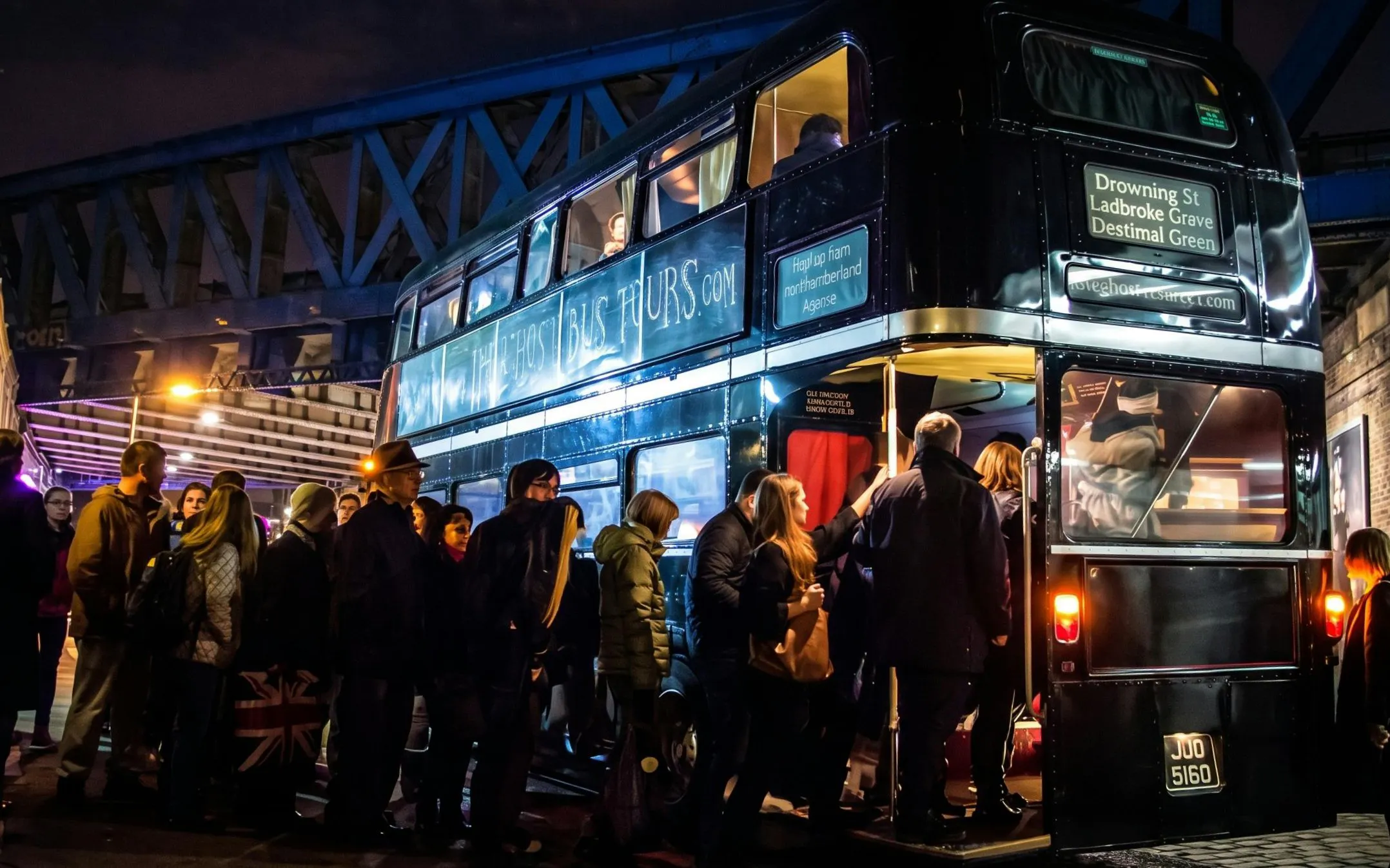 People boarding a double-decker bus for the London ghost bus tour at night.