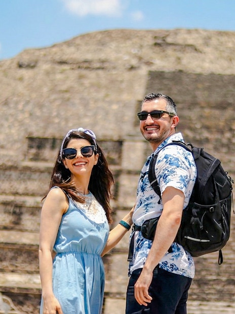 Couple smiling in front of Pyramid of the Sun, Teotihuacán, during balloon flight tour.