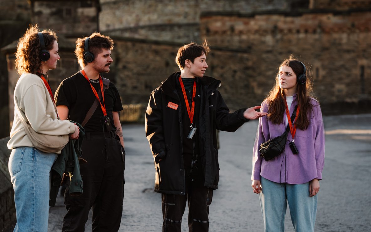 Tour group in Edinburgh discussing the Witches of Edinburgh: Trial and Truth experience.