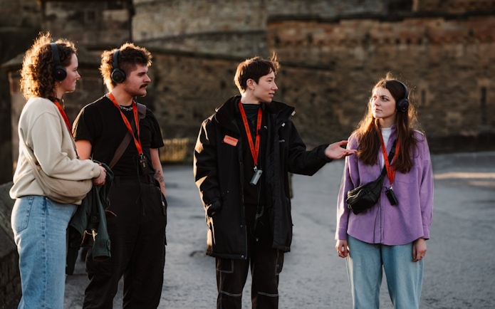 Tour group in Edinburgh discussing the Witches of Edinburgh: Trial and Truth experience.