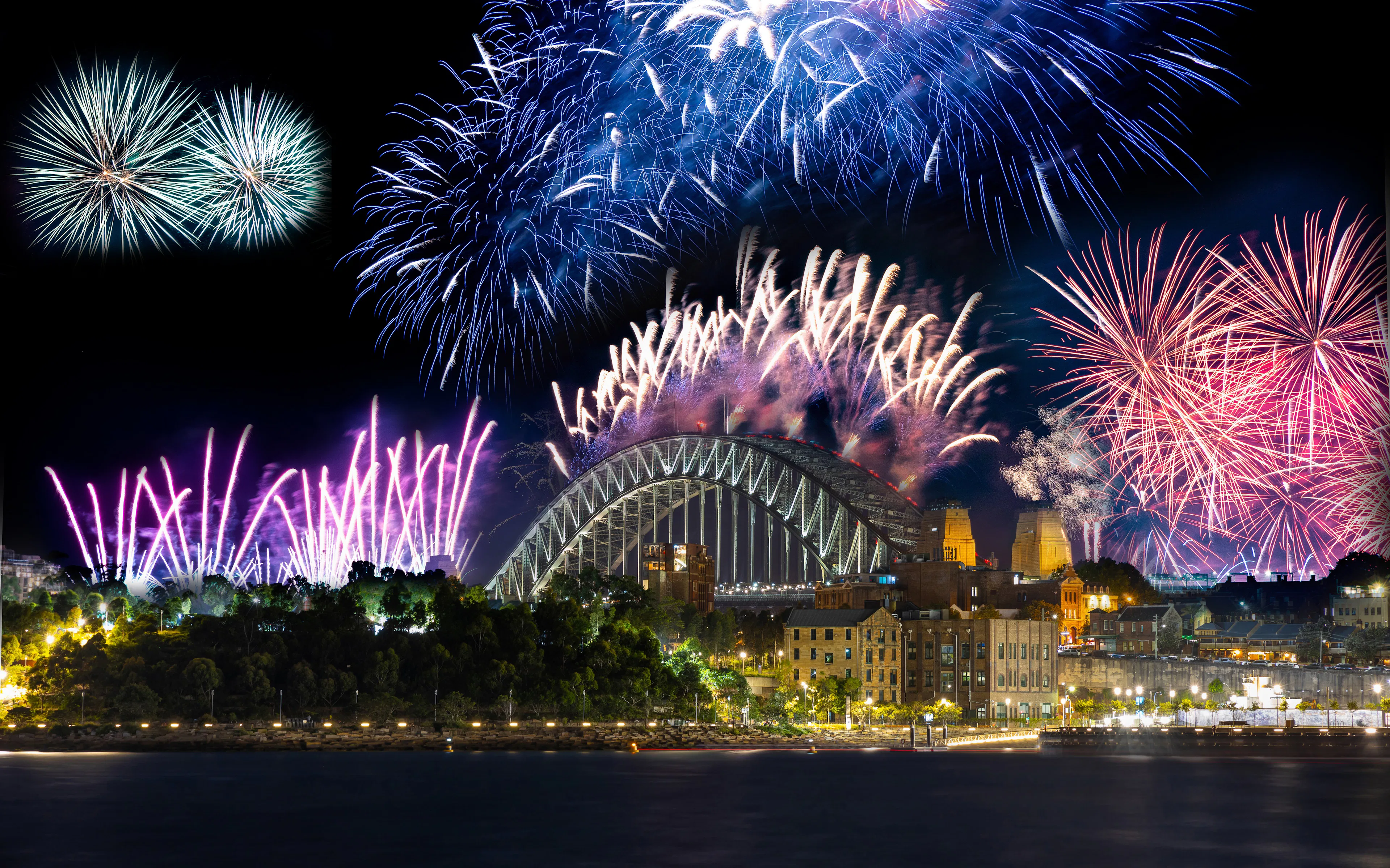 Sydney Harbour Bridge illuminated by New Year's Eve fireworks display.