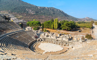 Ancient theater ruins in Ephesus, Turkey, with surrounding landscape.