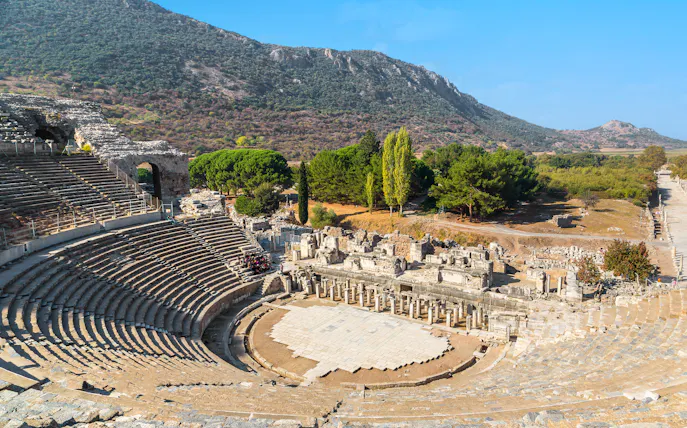 Ancient theater ruins in Ephesus, Turkey, with surrounding landscape.