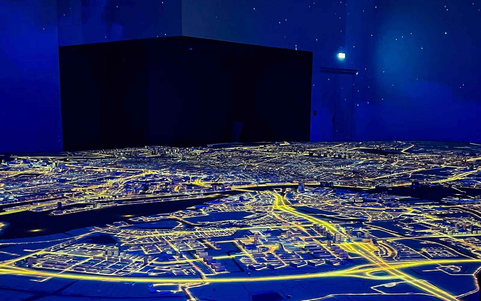 Illuminated cityscape model at Amsterdam in Motion exhibit.