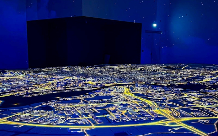 Illuminated cityscape model at Amsterdam in Motion exhibit.