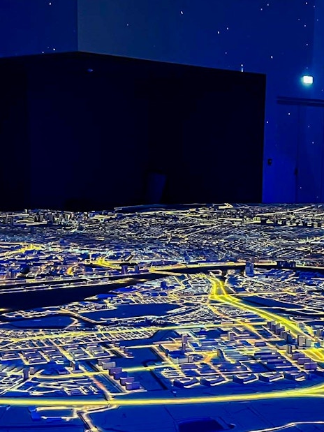 Illuminated cityscape model at Amsterdam in Motion exhibit.