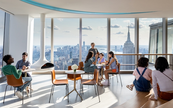People enjoying the view of the Empire State Building from SUMMIT One Vanderbilt in New York City.