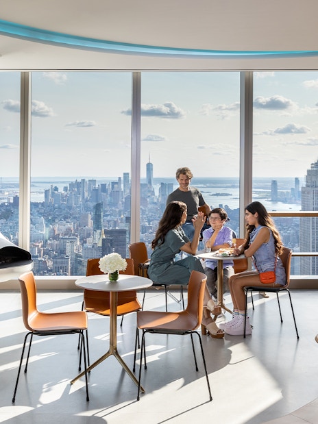 People enjoying the view of the Empire State Building from SUMMIT One Vanderbilt in New York City.