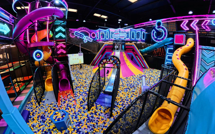 Indoor play area with colorful slides and ball pit at Loco Bear, Dubai.